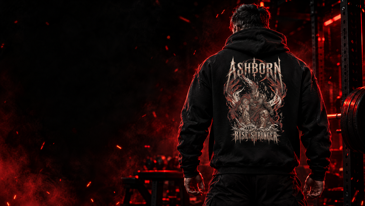 Athlete in the black SPARTAN RAGE Ashborn hoodie, back artwork reading Rise Stronger, in a dark gym